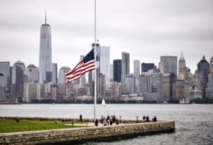 Amazing shot of the US flag in a park on the Manhattan skyline background