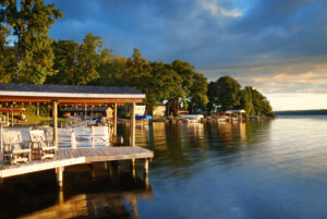 Lake house with pier and woods with sunrise in the morning in New York state Finger Lakes